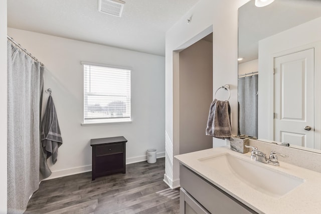 6432 Genevieve Trl S, Cottage Grove, MN 55016 - full bathroom with visible vents, vanity, wood finished floors, toilet, and baseboards