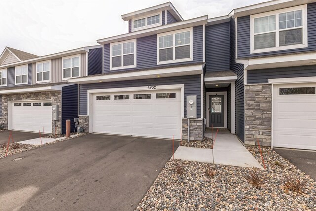 6432 Genevieve Trl S, Cottage Grove, MN 55016 - multi unit property with driveway, stone siding, and a garage