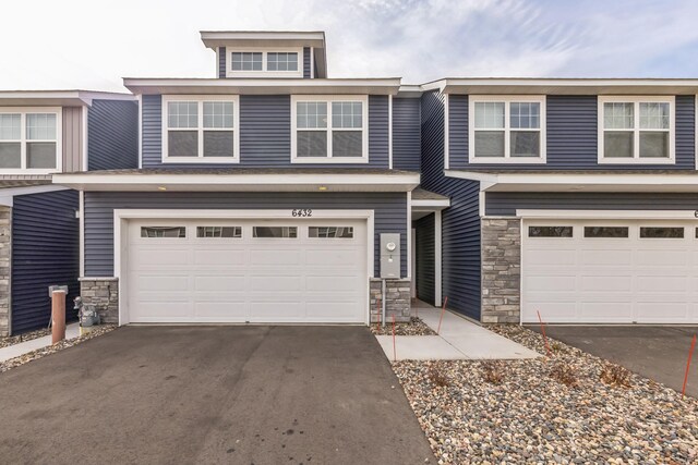 6432 Genevieve Trl S, Cottage Grove, MN 55016 - townhome / multi-family property featuring an attached garage, aphalt driveway, and stone siding