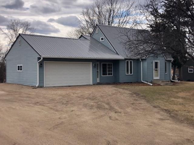 207 Astro Blvd W, Cosmos, MN 56228 - view of front facade featuring dirt driveway, metal roof, and a garage