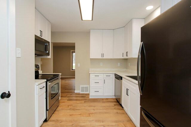 207 Astro Blvd W, Cosmos, MN 56228 - kitchen featuring light countertops, visible vents, stainless steel appliances, and light wood finished floors