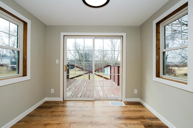 207 Astro Blvd W, Cosmos, MN 56228 - entryway featuring visible vents, baseboards, and wood finished floors