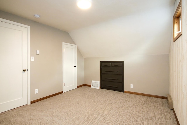 207 Astro Blvd W, Cosmos, MN 56228 - additional living space featuring vaulted ceiling, a baseboard heating unit, baseboards, carpet floors, and visible vents