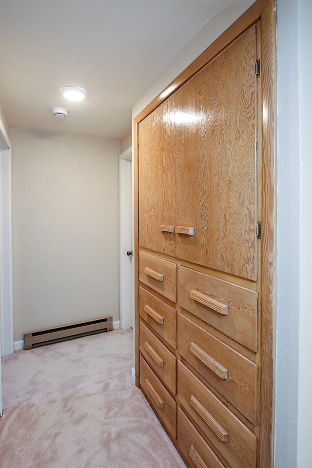 207 Astro Blvd W, Cosmos, MN 56228 - corridor featuring light carpet and a baseboard heating unit