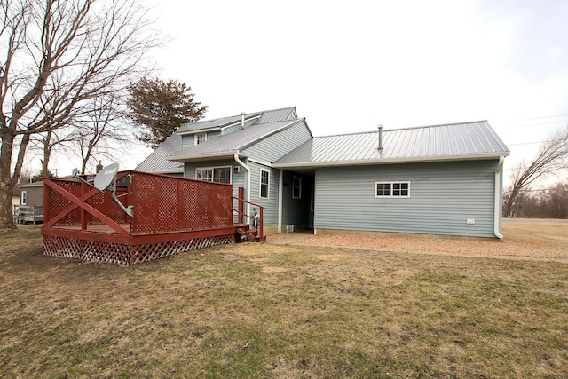 207 Astro Blvd W, Cosmos, MN 56228 - rear view of house with a deck, a yard, and metal roof
