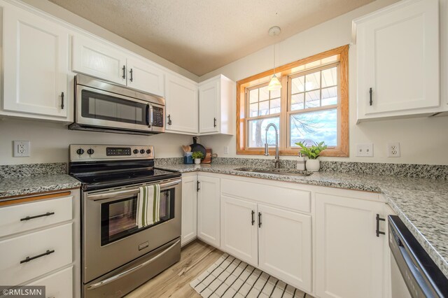 kitchen featuring white cabinetry, a sink, and stainless steel appliances