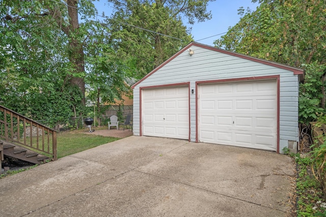 detached garage featuring fence