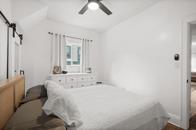 bedroom featuring lofted ceiling, wood finished floors, and ceiling fan
