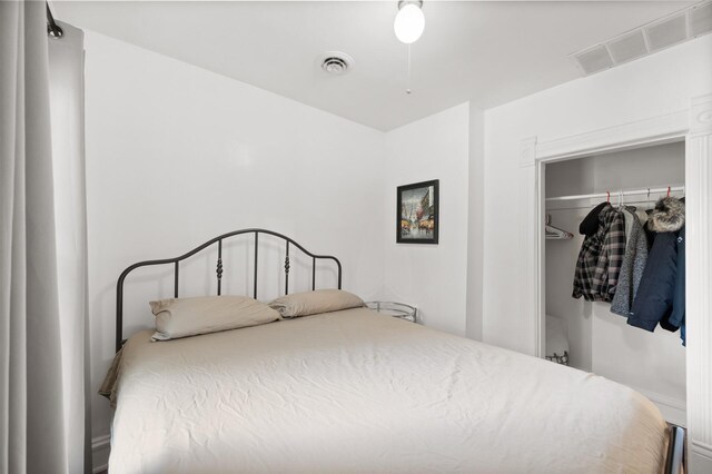 bedroom with visible vents and a closet