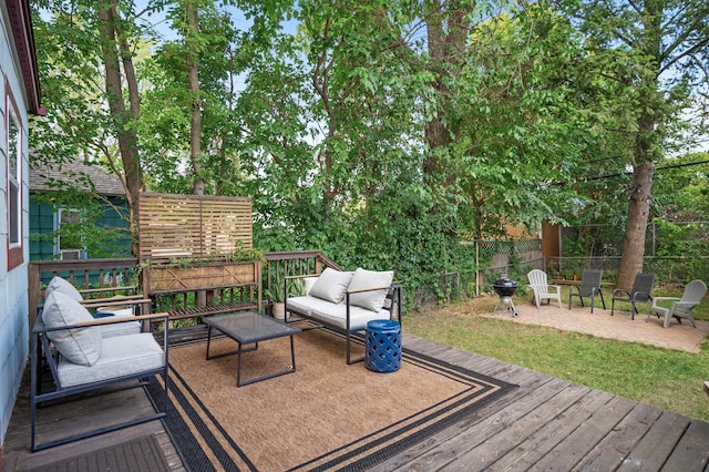 wooden deck featuring an outdoor hangout area and fence