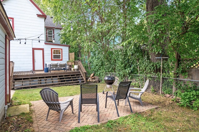 view of yard with a deck, a fenced backyard, and a patio area