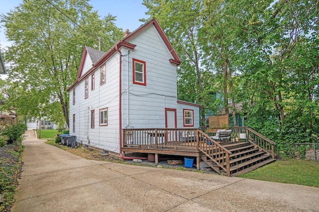rear view of property featuring a deck and a chimney