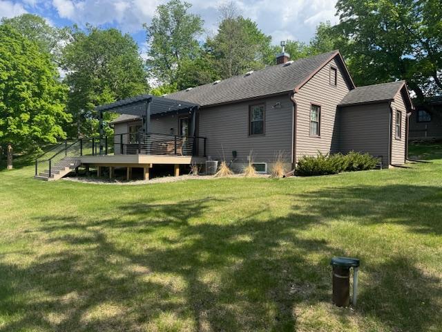 616 Lake Cowdry Rd NW, Alexandria, MN 56308 - rear view of house featuring a deck, a pergola, a yard, and a chimney