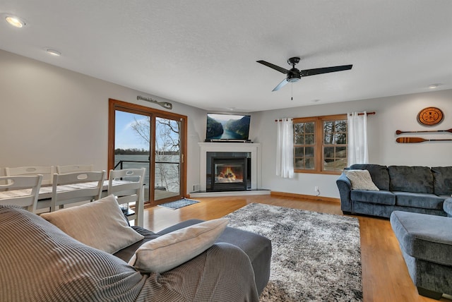 616 Lake Cowdry Rd NW, Alexandria, MN 56308 - living room with ceiling fan, a tile fireplace, wood finished floors, and recessed lighting