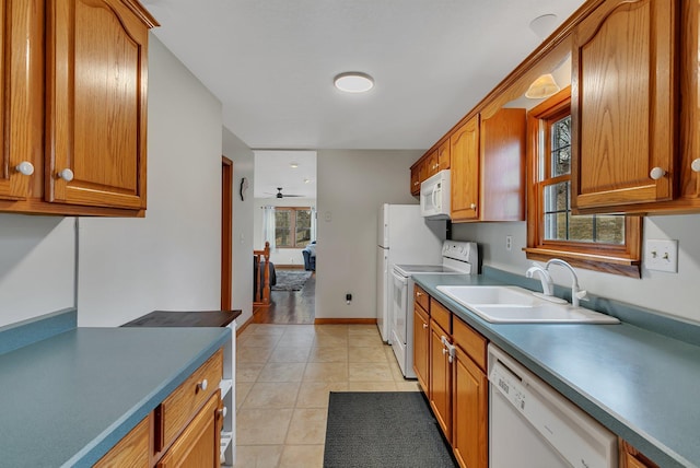 616 Lake Cowdry Rd NW, Alexandria, MN 56308 - kitchen featuring white appliances, brown cabinetry, and light tile patterned floors