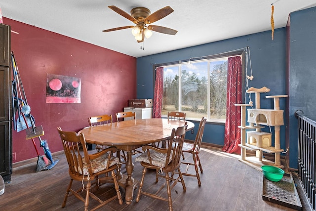 dining space with baseboards, ceiling fan, and hardwood / wood-style flooring