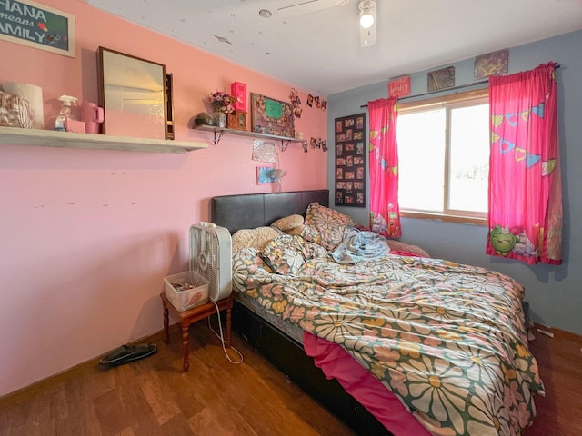 bedroom with baseboards, a ceiling fan, and wood finished floors