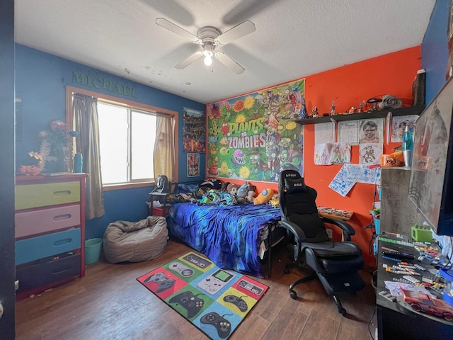 bedroom with a ceiling fan and wood finished floors