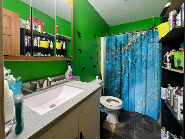 bathroom with a shower with curtain, stone finish flooring, a textured ceiling, vanity, and toilet