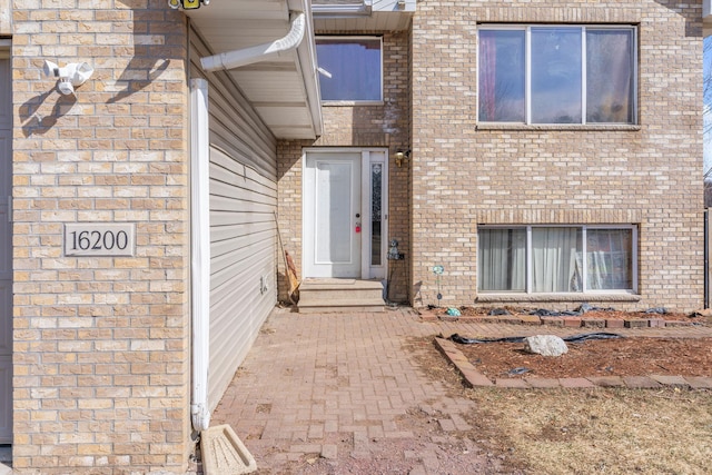 property entrance with brick siding