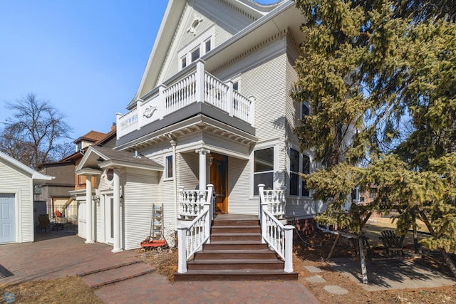 view of front facade with a balcony and a porch