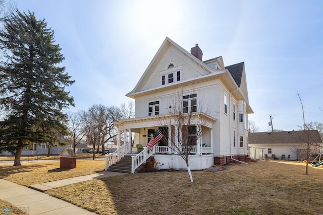 view of front of property with a porch and a chimney