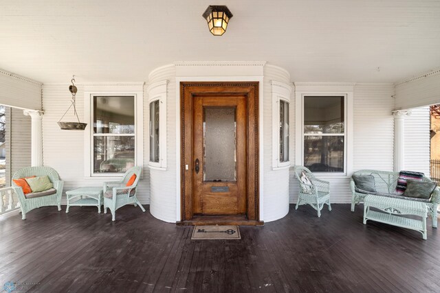 view of exterior entry featuring covered porch