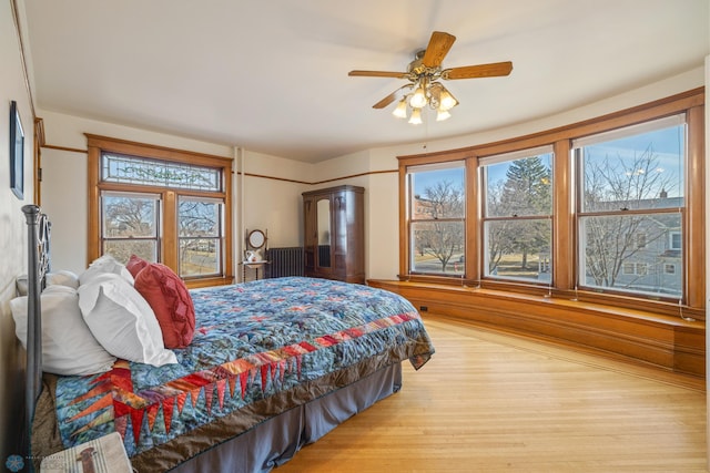 bedroom featuring light wood-style flooring and multiple windows