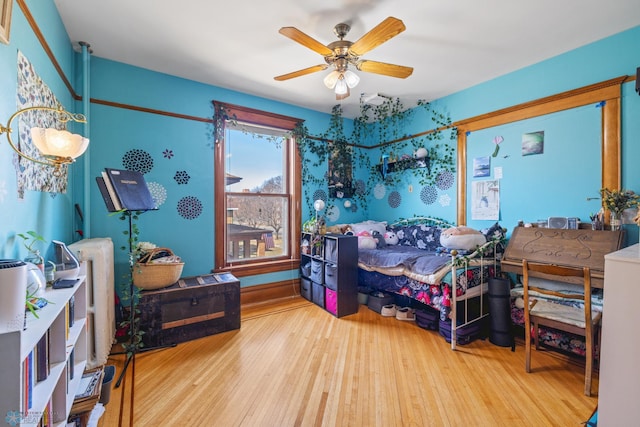 bedroom featuring wood finished floors and a ceiling fan