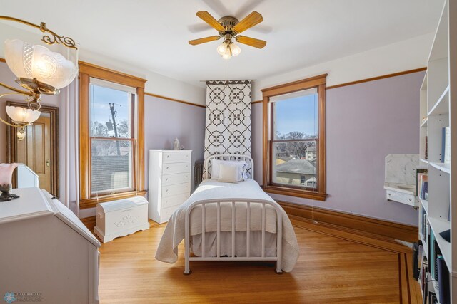 bedroom with baseboards and wood finished floors