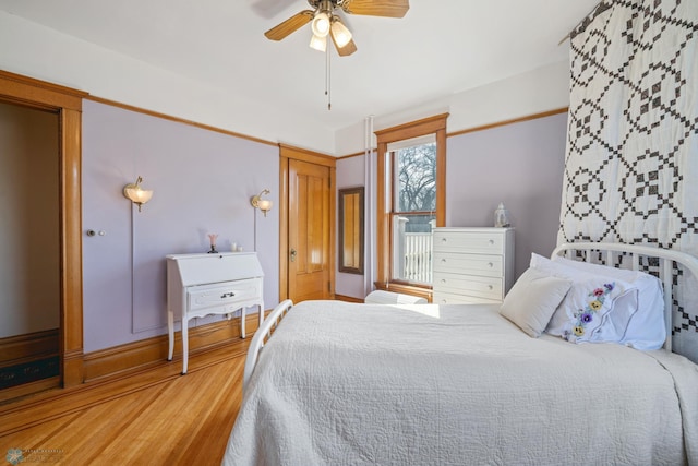 bedroom with ceiling fan and wood finished floors