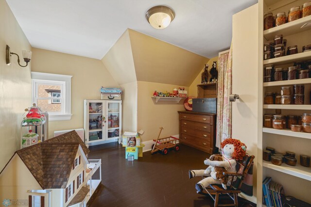 rec room featuring baseboards, vaulted ceiling, and wood finished floors