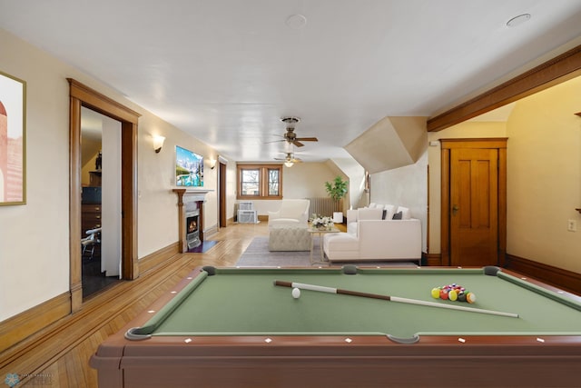 recreation room featuring a lit fireplace, a ceiling fan, pool table, and vaulted ceiling
