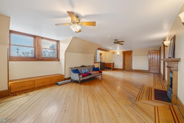 interior space with baseboards, a ceiling fan, and hardwood / wood-style flooring