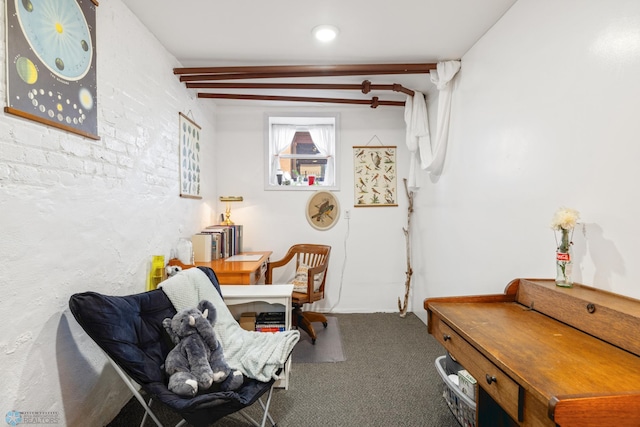 sitting room with carpet flooring and beam ceiling