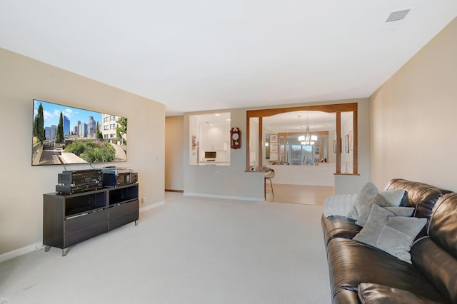 8651 Basswood Rd Unit 203, Eden Prairie, MN 55344 - living room featuring an inviting chandelier, light colored carpet, and baseboards