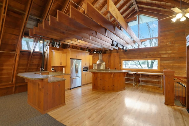 8651 Basswood Rd Unit 203, Eden Prairie, MN 55344 - kitchen featuring wooden walls, a skylight, light wood-type flooring, and stainless steel appliances