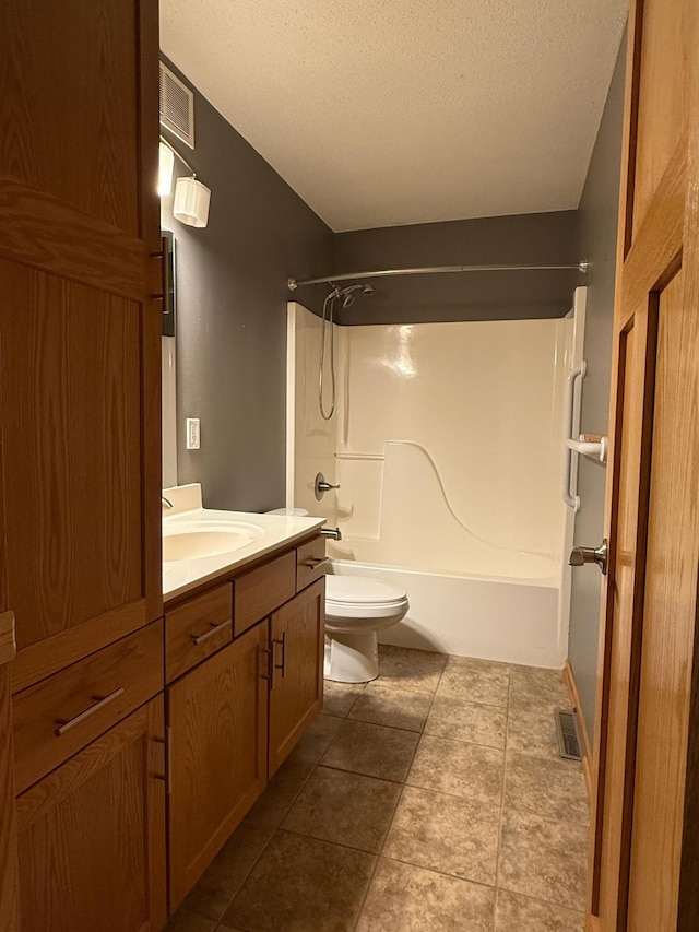bathroom with visible vents, toilet, vanity, tub / shower combination, and a textured ceiling
