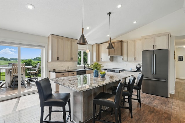 27901 Teale Ave, New Prague, MN 56071 - kitchen with freestanding refrigerator, dark wood finished floors, a sink, light brown cabinetry, and vaulted ceiling