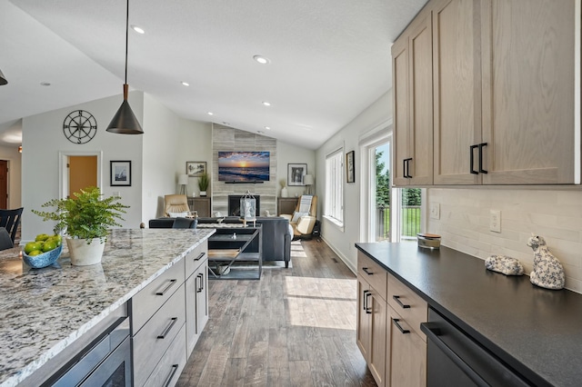 27901 Teale Ave, New Prague, MN 56071 - kitchen with lofted ceiling, wood finished floors, a large fireplace, light brown cabinets, and decorative backsplash