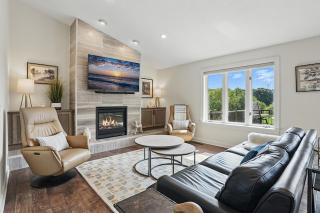 27901 Teale Ave, New Prague, MN 56071 - living room featuring a tiled fireplace, wood finished floors, recessed lighting, baseboards, and high vaulted ceiling