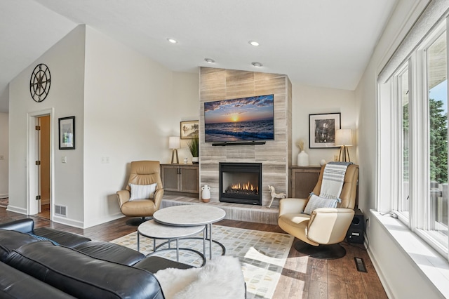 27901 Teale Ave, New Prague, MN 56071 - living area with wood finished floors, a tiled fireplace, baseboards, high vaulted ceiling, and recessed lighting