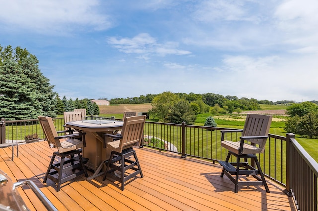 27901 Teale Ave, New Prague, MN 56071 - wooden terrace with outdoor dining space, a lawn, and view of wooded area