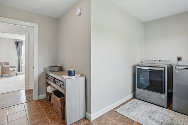 27901 Teale Ave, New Prague, MN 56071 - washroom featuring washing machine and dryer, tile patterned flooring, and baseboards