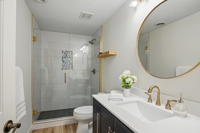 27901 Teale Ave, New Prague, MN 56071 - full bathroom featuring toilet, a stall shower, vanity, and wood finished floors