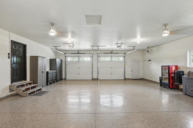 27901 Teale Ave, New Prague, MN 56071 - garage with a garage door opener, a ceiling fan, and baseboards