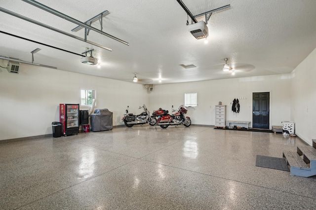 27901 Teale Ave, New Prague, MN 56071 - garage featuring a garage door opener and baseboards