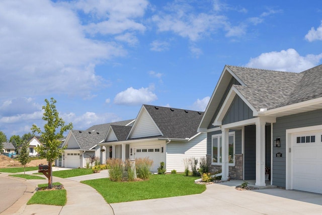 view of front of home featuring driveway, a shingled roof, an attached garage, and board and batten siding