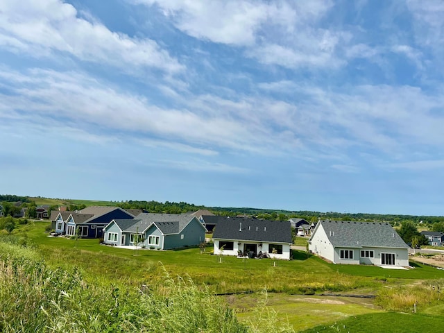 back of house with a lawn and a residential view