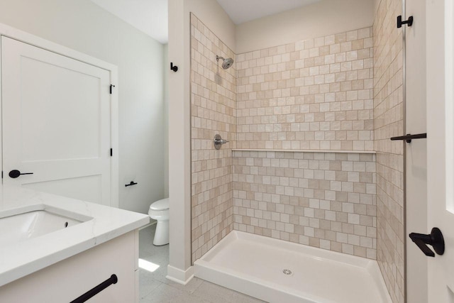 bathroom with toilet, vanity, and a shower stall